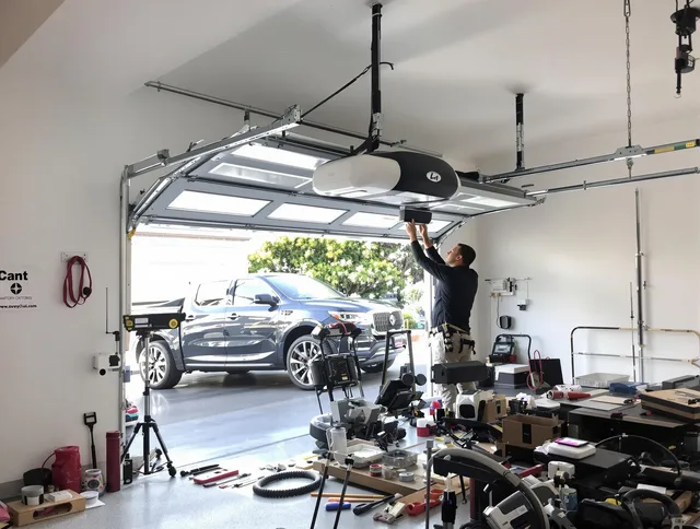Monroe Garage Door Repair specialist installing smart garage door opener system in Monroe home